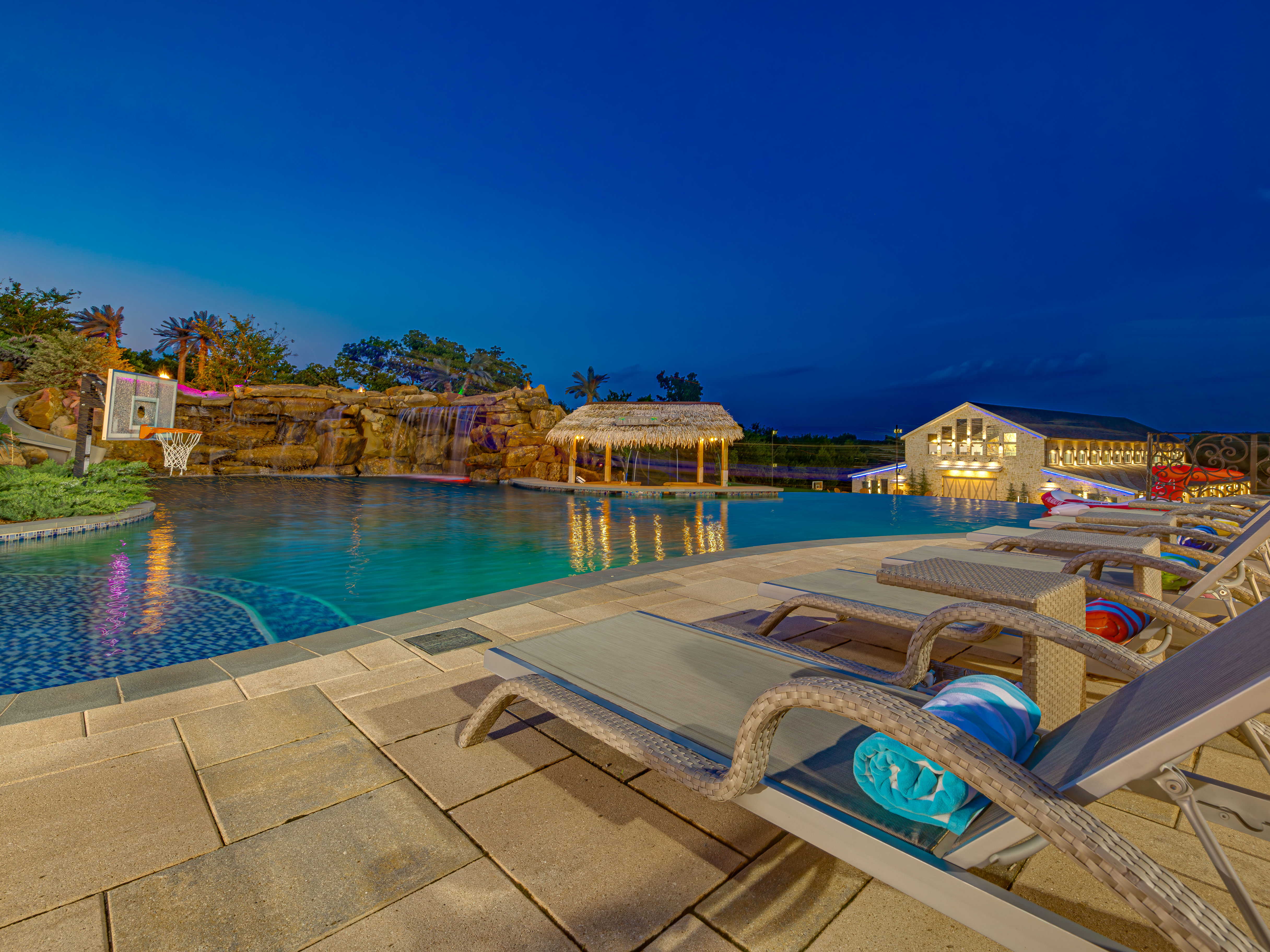 Pool and Grounds — resort pool with rock waterfall and in-pool basketball