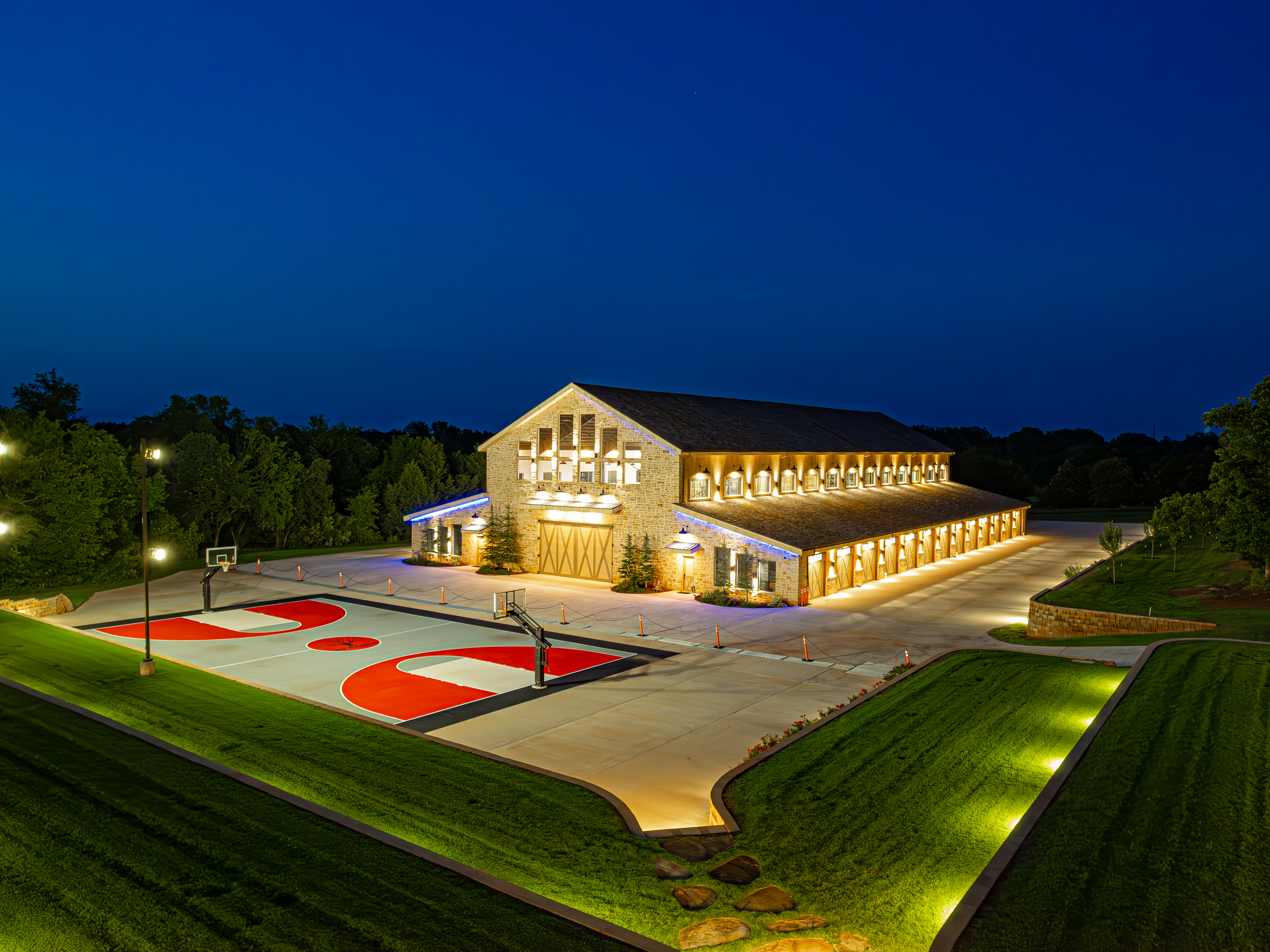 The Barn and private court illuminated at night