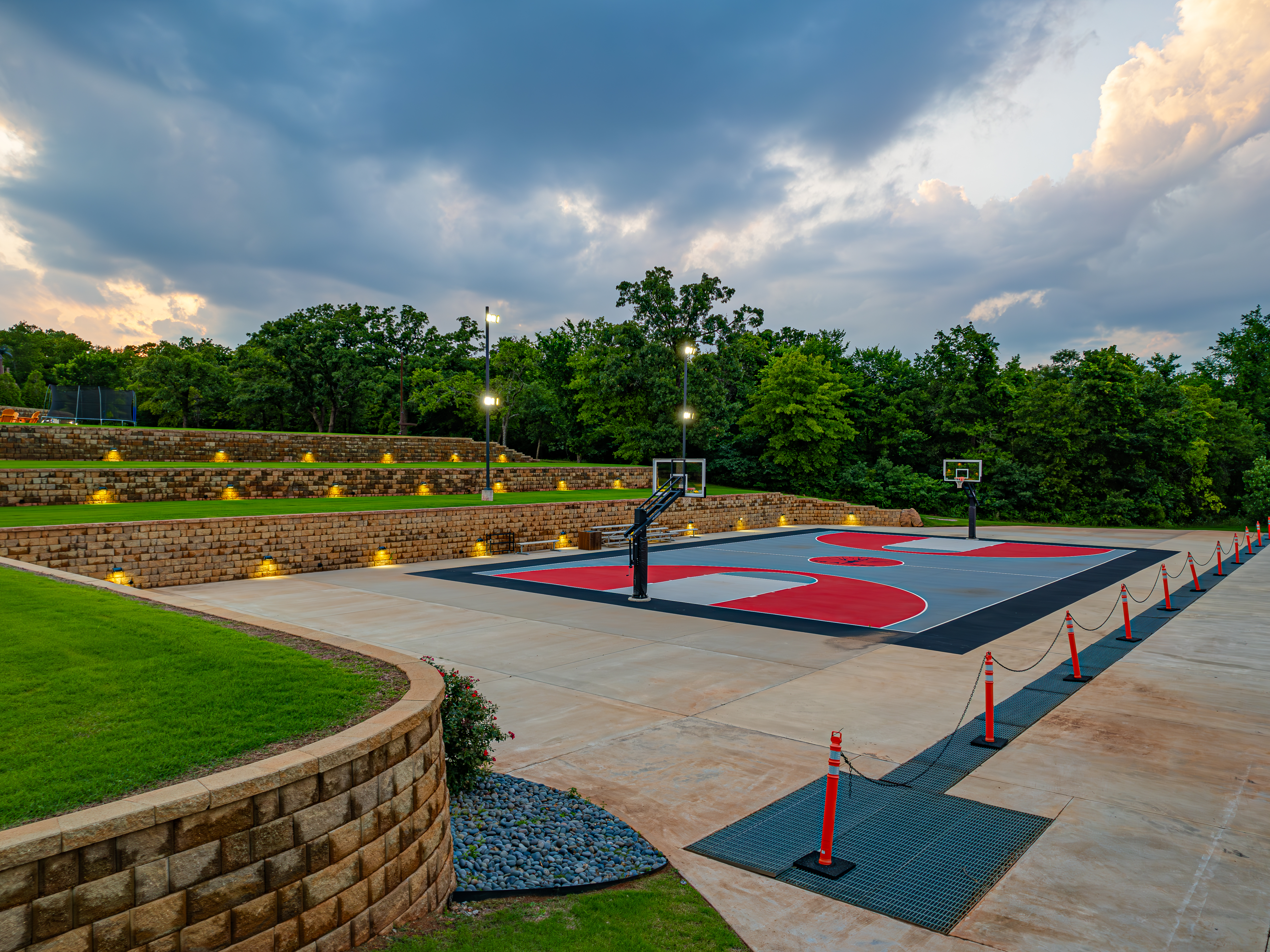 Private full-size court at twilight with stadium lighting